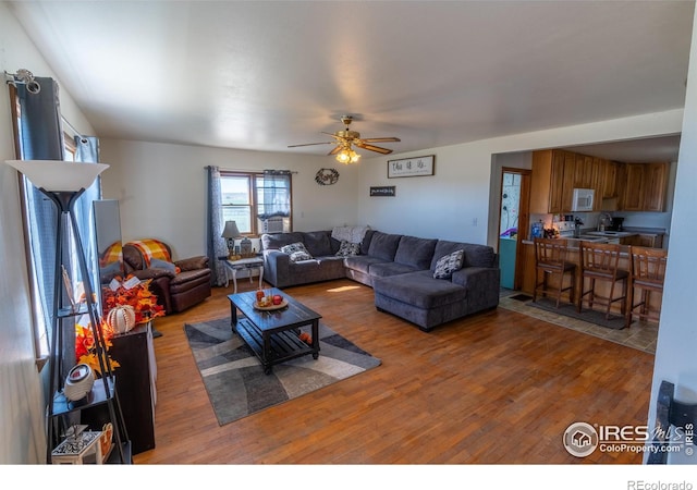 living room featuring hardwood / wood-style flooring and ceiling fan