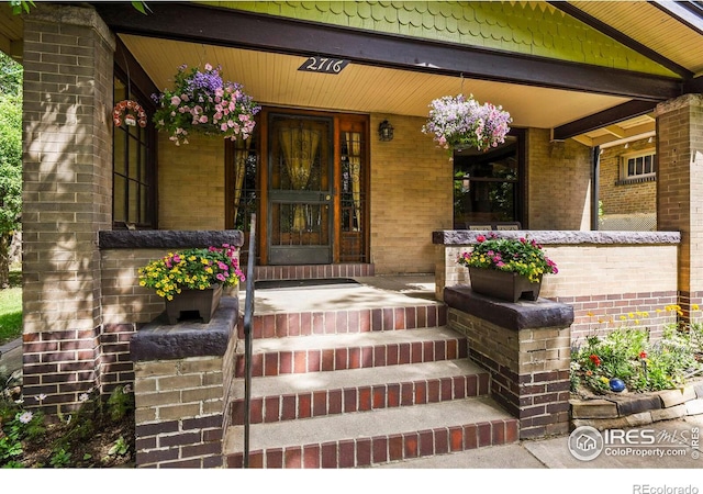 view of exterior entry with covered porch