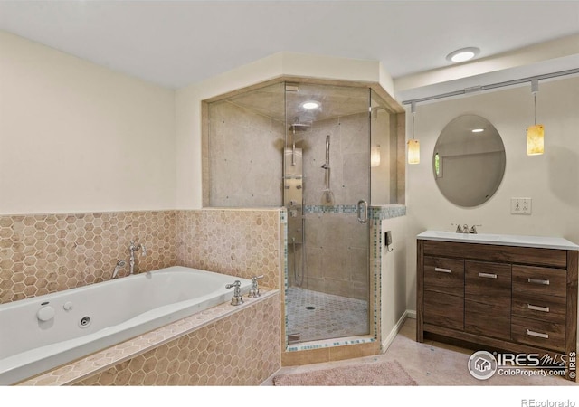 bathroom with separate shower and tub and vanity