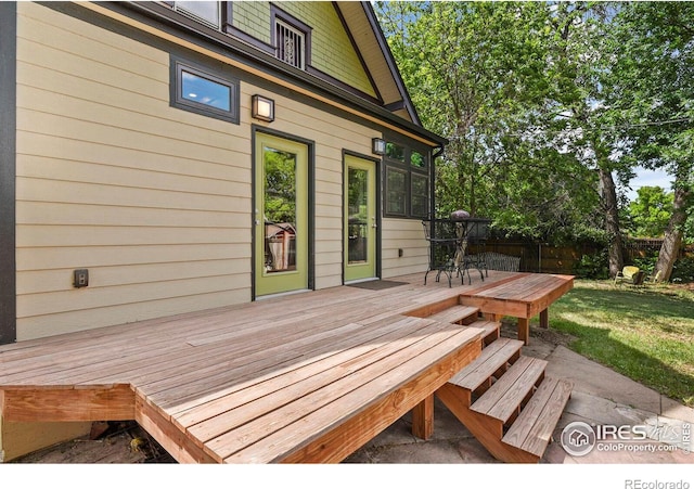 wooden deck featuring a yard