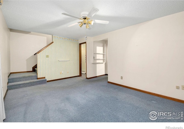 carpeted empty room with a textured ceiling and ceiling fan