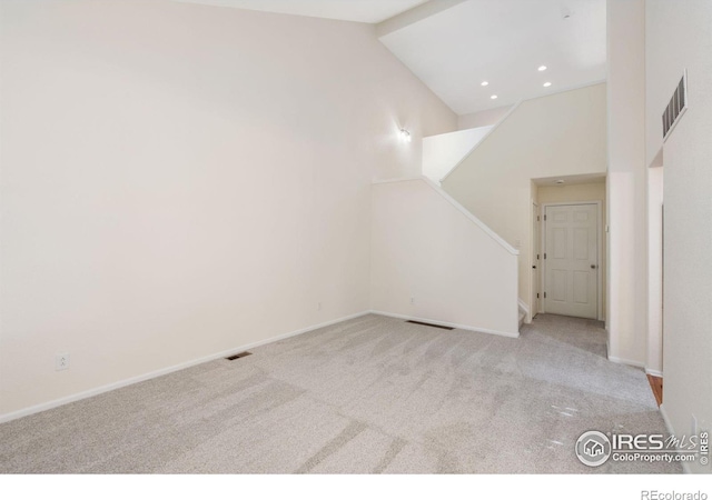 bonus room featuring light colored carpet and high vaulted ceiling