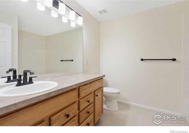 bathroom with vanity and toilet