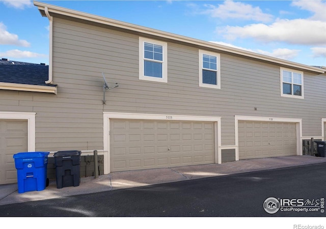 view of side of home featuring a garage