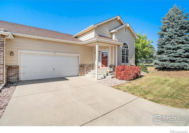 view of front of property with a garage and a front lawn