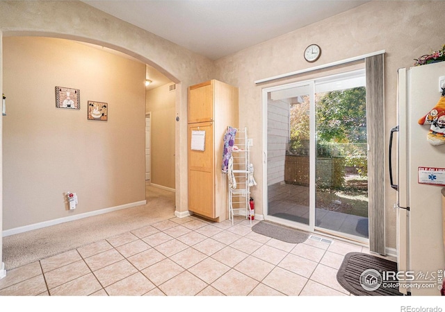 entryway with light tile patterned flooring