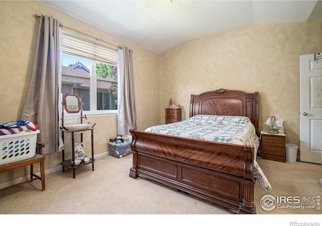 carpeted bedroom featuring ceiling fan and vaulted ceiling