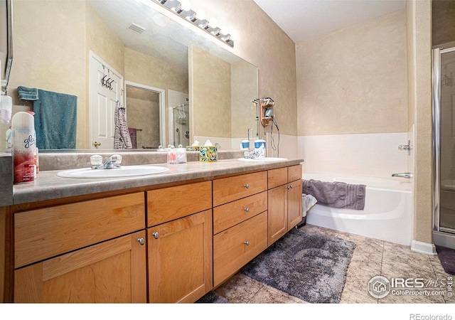 bathroom with independent shower and bath, vanity, and tile patterned flooring