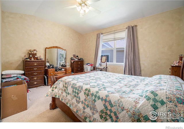 carpeted bedroom featuring lofted ceiling and ceiling fan