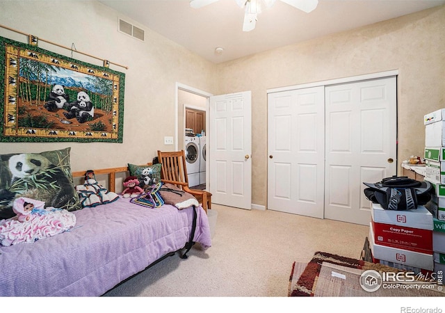 carpeted bedroom with independent washer and dryer, a closet, and ceiling fan