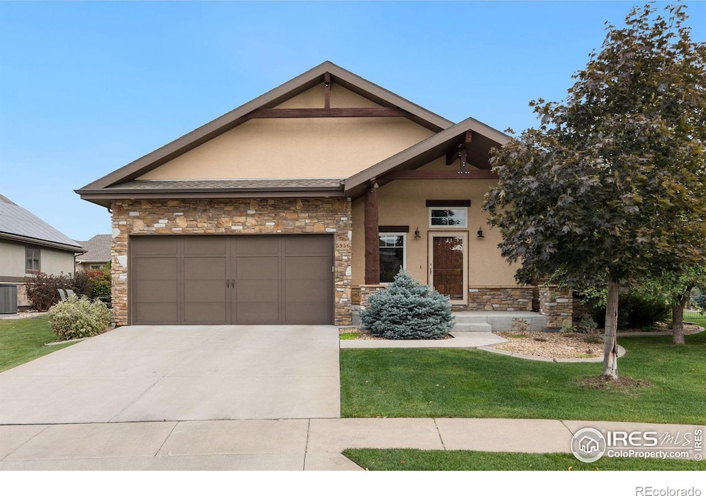 view of front of house featuring a front lawn, central air condition unit, and a garage