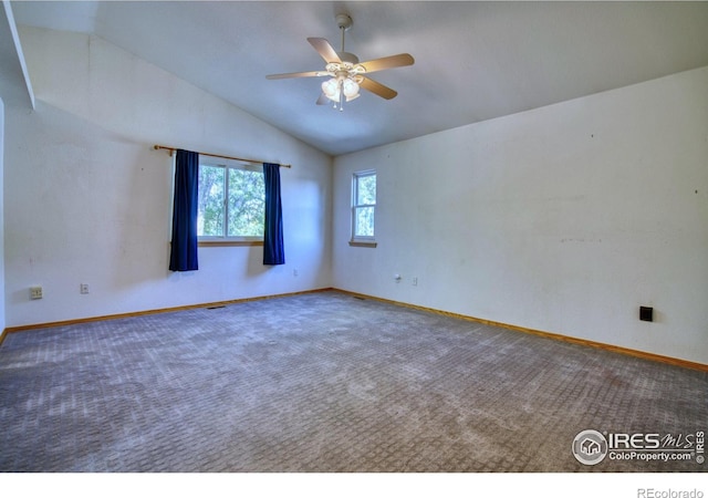 carpeted empty room featuring ceiling fan and vaulted ceiling