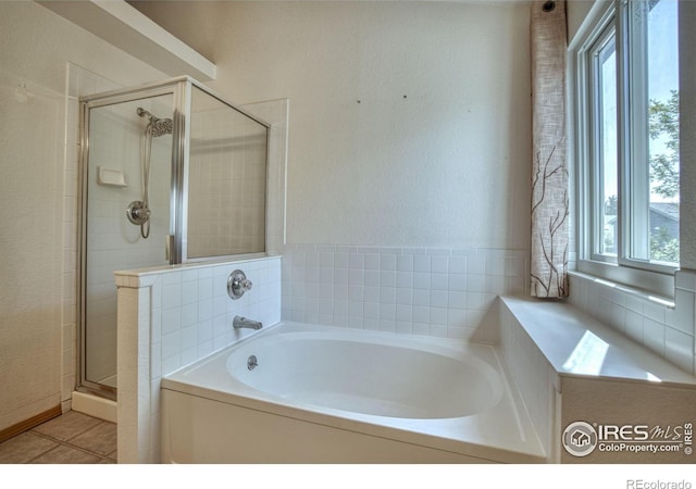 bathroom featuring plus walk in shower and tile patterned floors