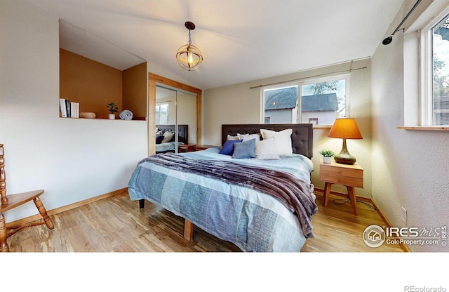 bedroom with a closet and light hardwood / wood-style floors