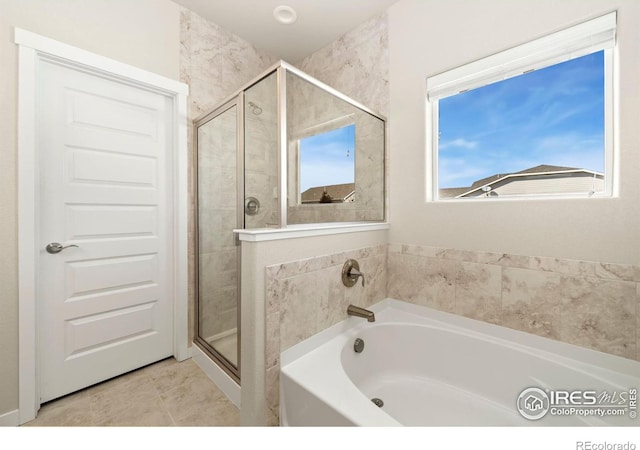 bathroom with tile patterned flooring and separate shower and tub