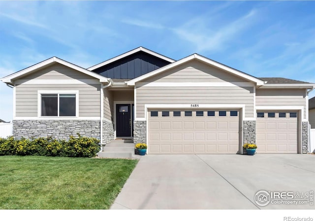 craftsman-style home featuring a front yard and a garage