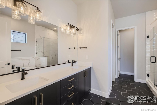 bathroom featuring a shower with shower door, vanity, and tile patterned flooring