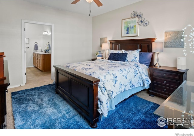 bedroom with ensuite bathroom, ceiling fan, and carpet