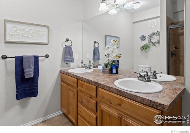 bathroom featuring tile patterned flooring, vanity, an enclosed shower, and toilet