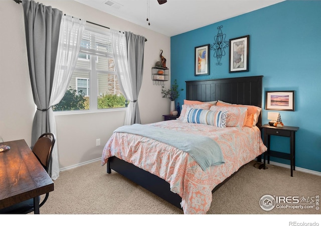 bedroom with light colored carpet and ceiling fan