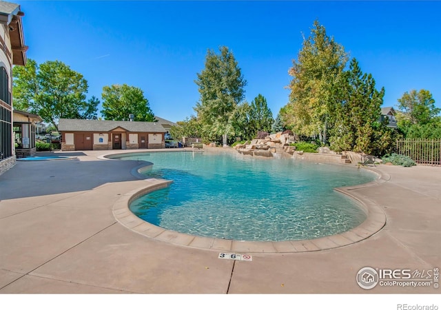 view of swimming pool with a patio area