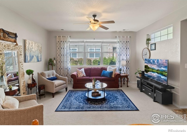 carpeted living room with ceiling fan