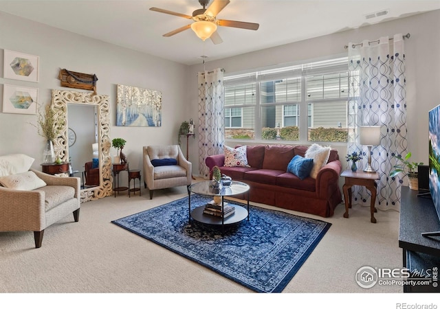 living room with ceiling fan and carpet flooring