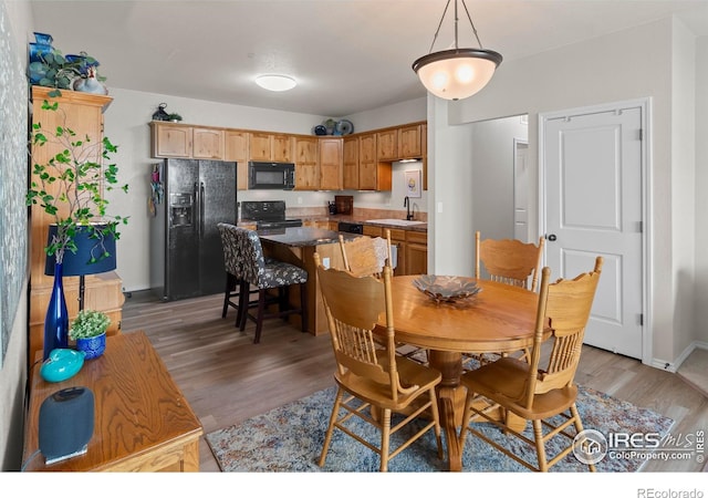 dining space with dark hardwood / wood-style flooring and sink