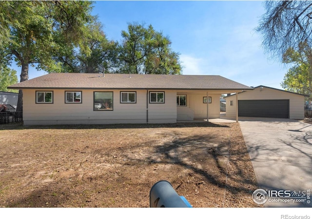 ranch-style house featuring a garage and an outbuilding