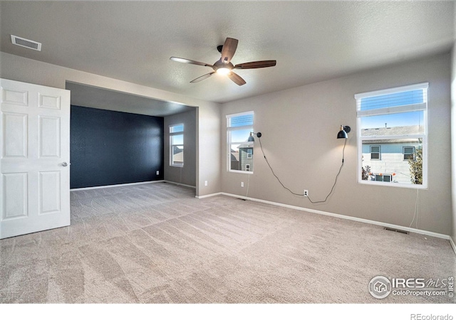 carpeted empty room with ceiling fan