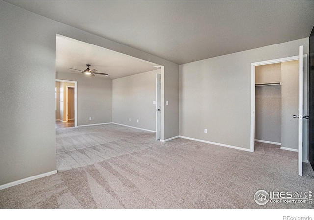 carpeted empty room featuring ceiling fan