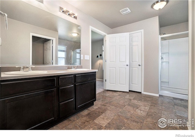 bathroom with vanity and a shower with shower door