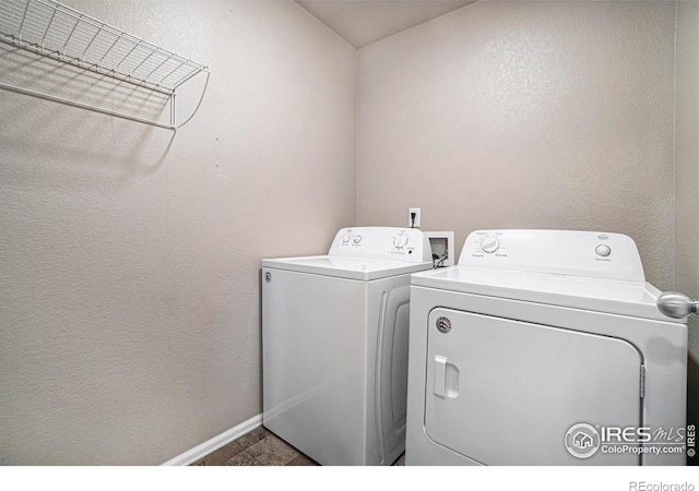 clothes washing area with washer and dryer and tile patterned floors