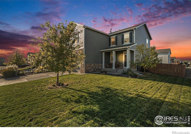 view of front of house with a porch and a yard