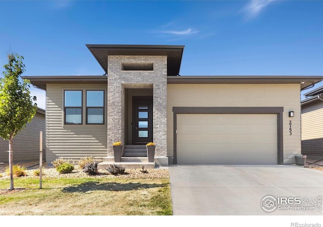 prairie-style home with a garage and a front yard