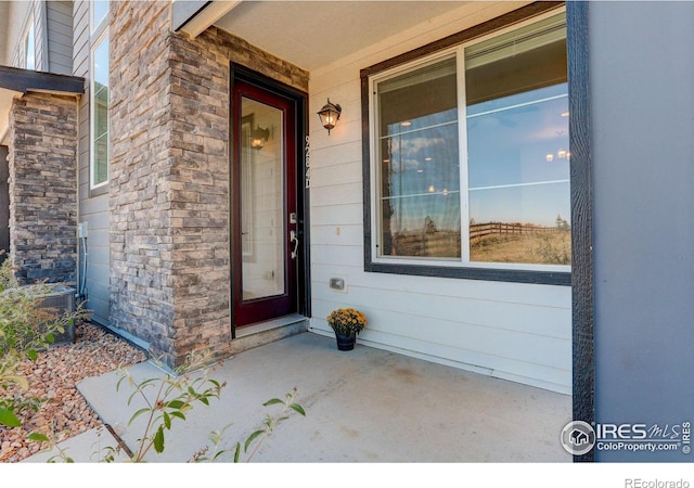 doorway to property featuring central AC