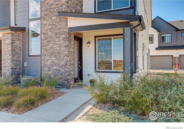 doorway to property with a garage