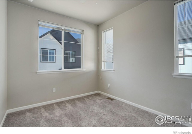 empty room featuring light colored carpet