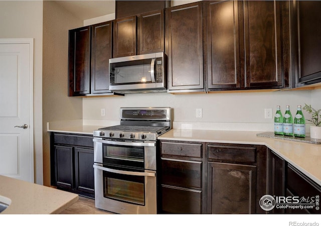 kitchen featuring dark brown cabinetry and stainless steel appliances