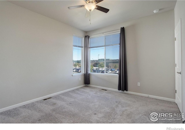 spare room with light carpet and ceiling fan