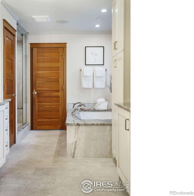 bathroom featuring vanity, tile patterned floors, and plus walk in shower