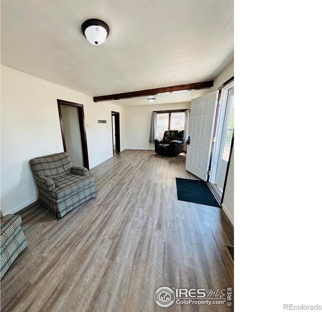 130 W 4th St N, Cheyenne Wells, CO 80810 - interior space with light hardwood / wood-style floors, beamed ceiling, and a textured ceiling