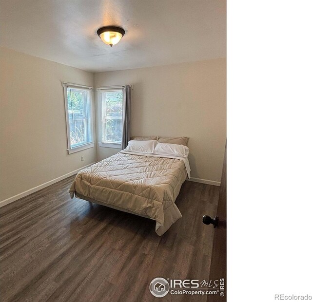 130 W 4th St N, Cheyenne Wells, CO 80810 - bedroom with dark hardwood / wood-style flooring