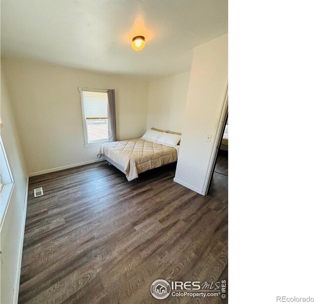 130 W 4th St N, Cheyenne Wells, CO 80810 - unfurnished bedroom featuring dark hardwood / wood-style floors