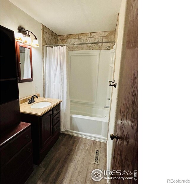 130 W 4th St N, Cheyenne Wells, CO 80810 - bathroom featuring hardwood / wood-style flooring, shower / bath combo, and vanity