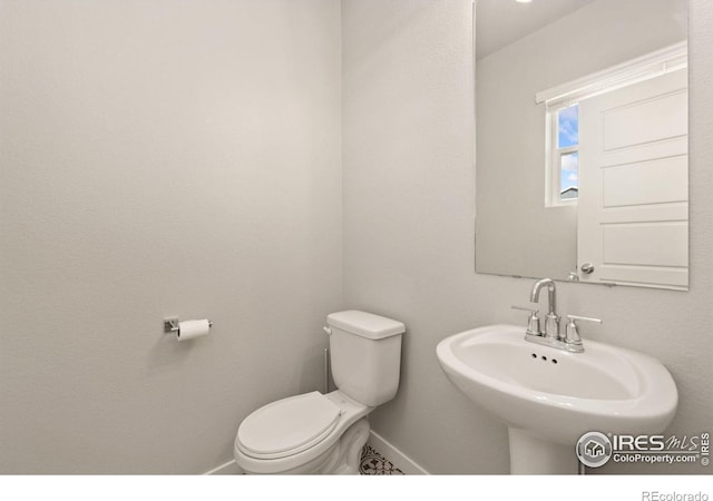 bathroom featuring toilet and sink