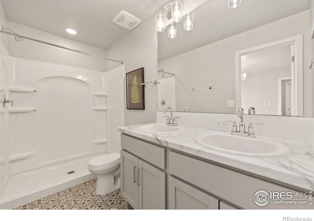 bathroom featuring walk in shower, tile patterned floors, toilet, and vanity