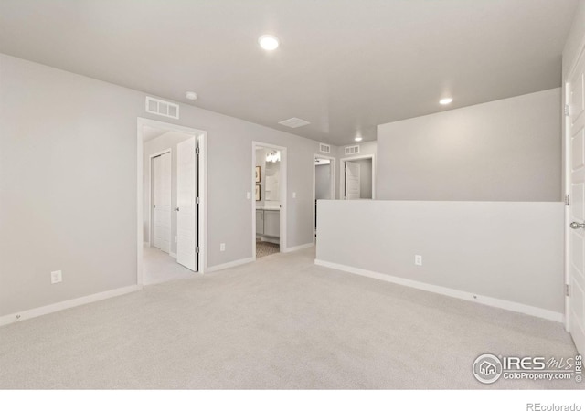 spare room featuring light colored carpet