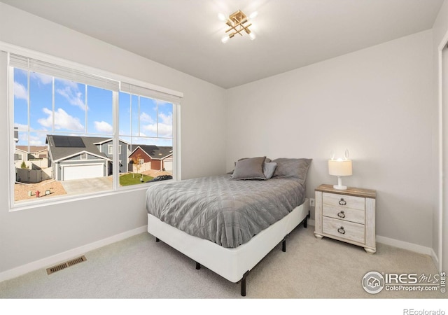 bedroom featuring light colored carpet