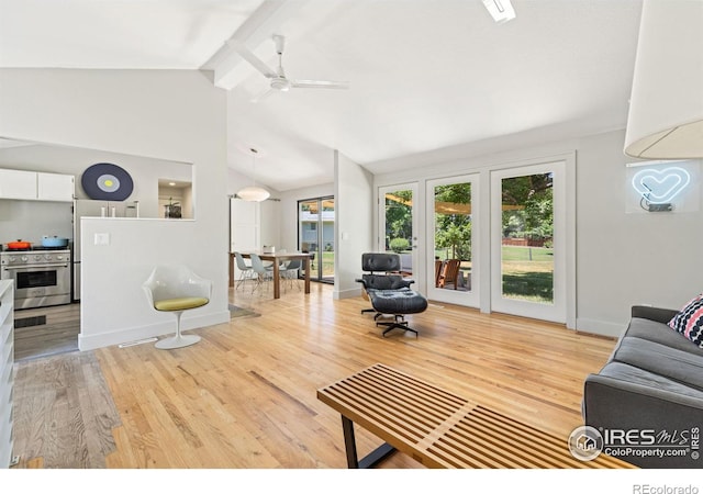 living room featuring ceiling fan, light hardwood / wood-style flooring, and vaulted ceiling with beams